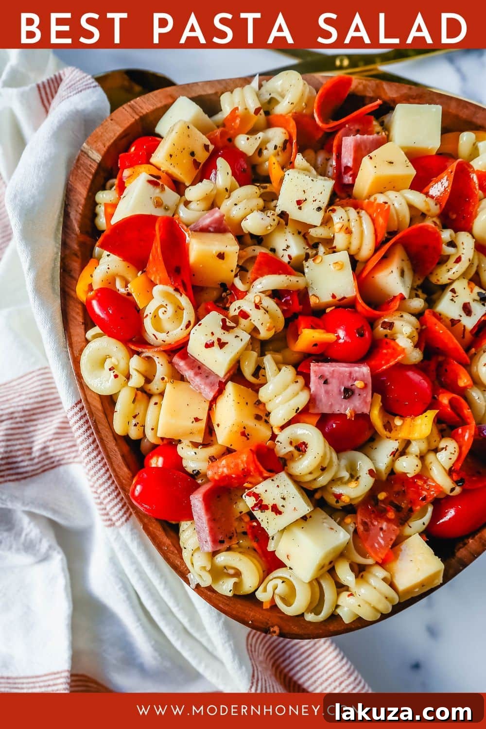 Classic Pasta Salad served in a bowl, garnished with fresh basil