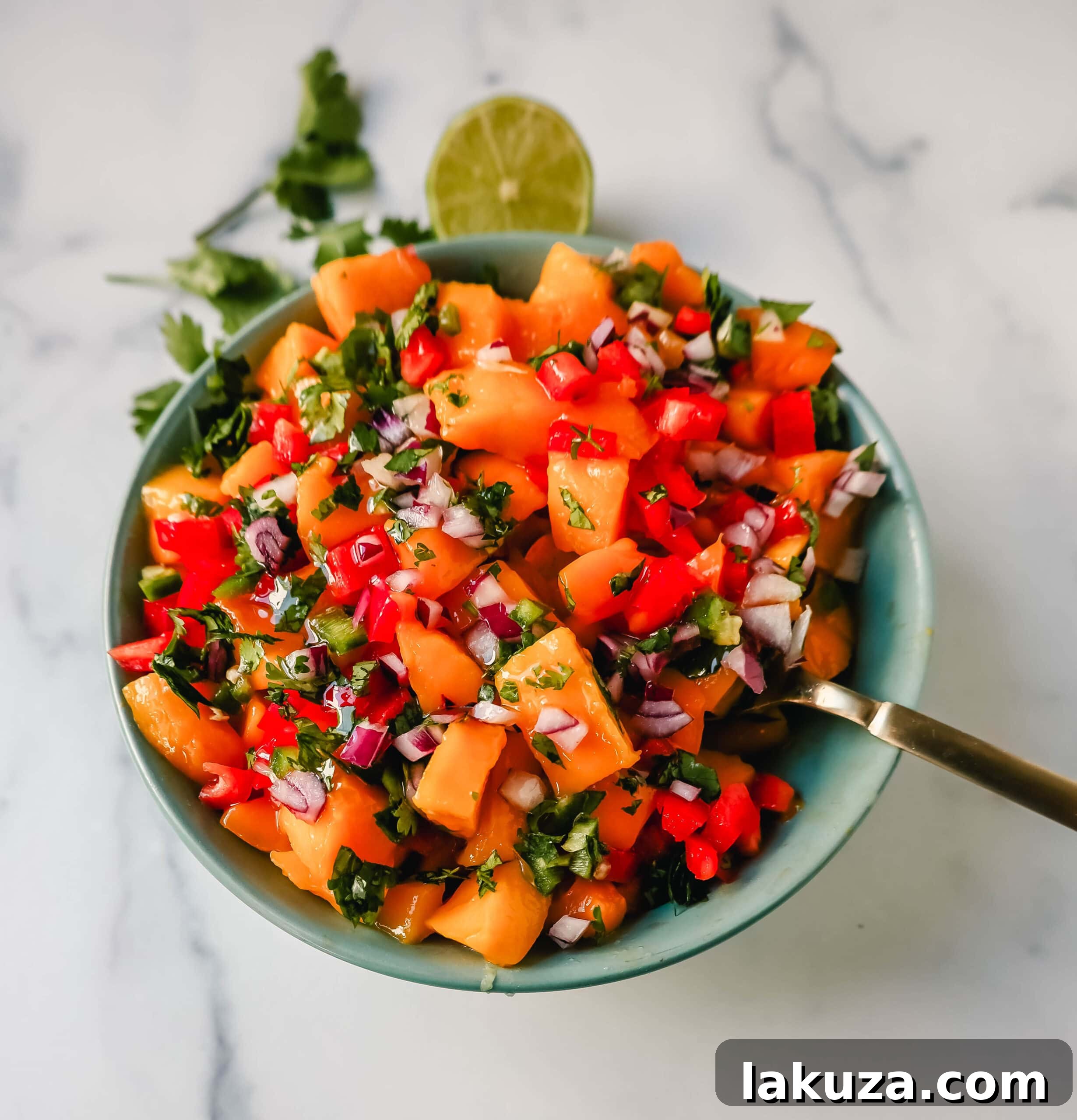 Tropical Mango Salsa 3 An overhead shot of homemade fresh mango salsa in a glass bowl, showcasing the colorful ingredients.