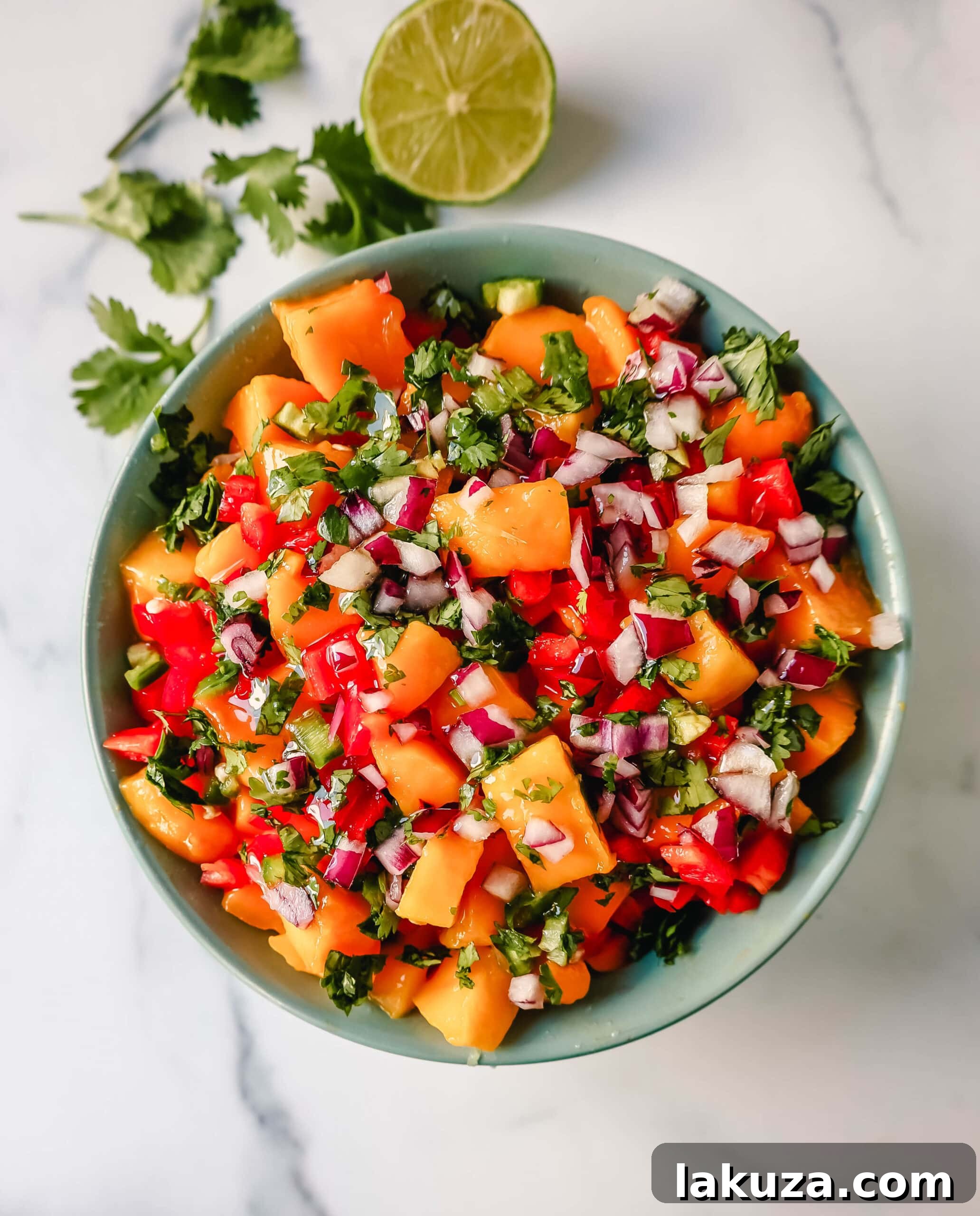 Tropical Mango Salsa 4 A side view of a glass bowl filled with fresh mango salsa, highlighting the diced ingredients.