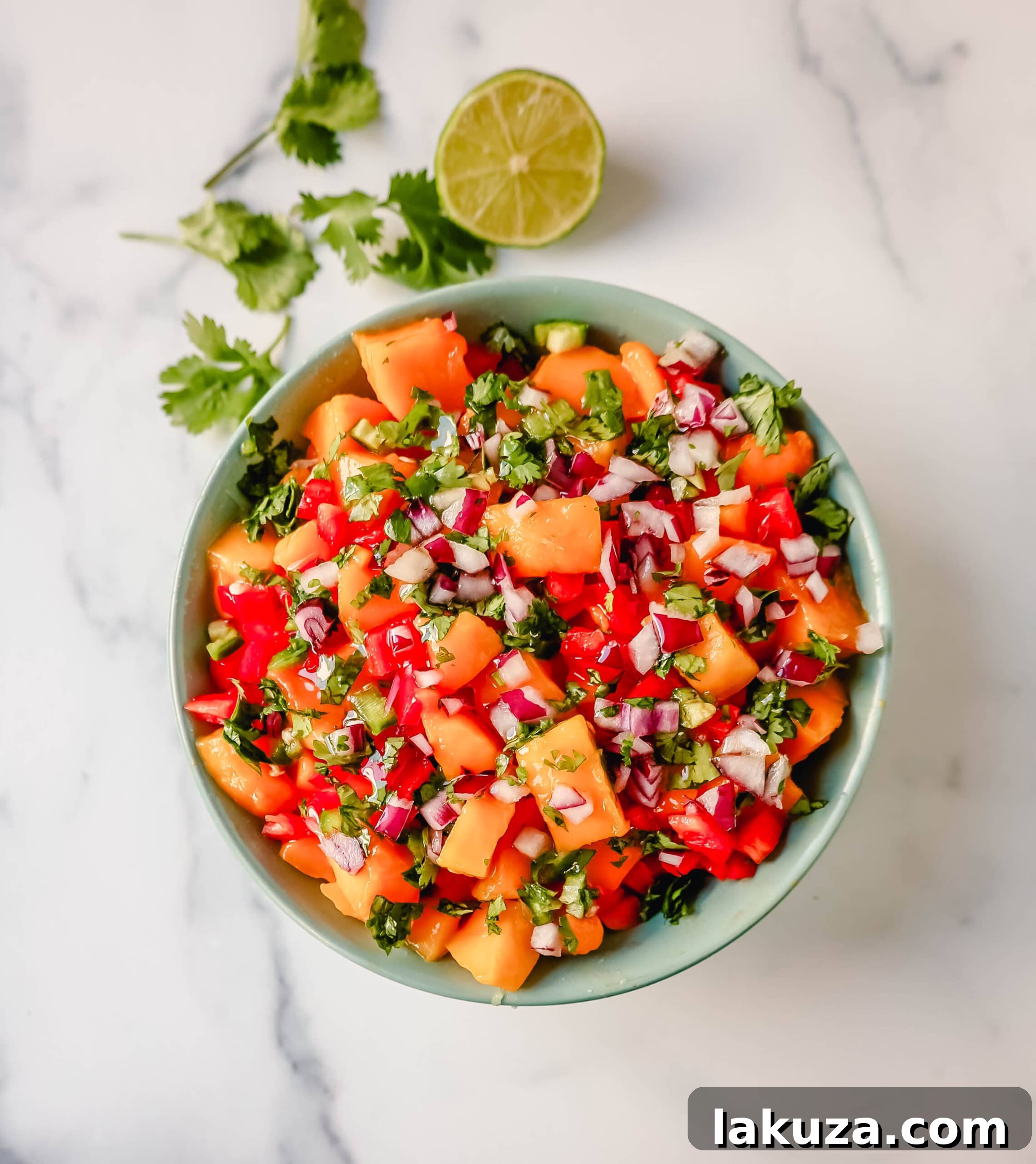 Tropical Mango Salsa 5 Four glass bowls, each containing a different variety of salsa, including fresh mango salsa, peach salsa, and green salsa, with a spoon in each.