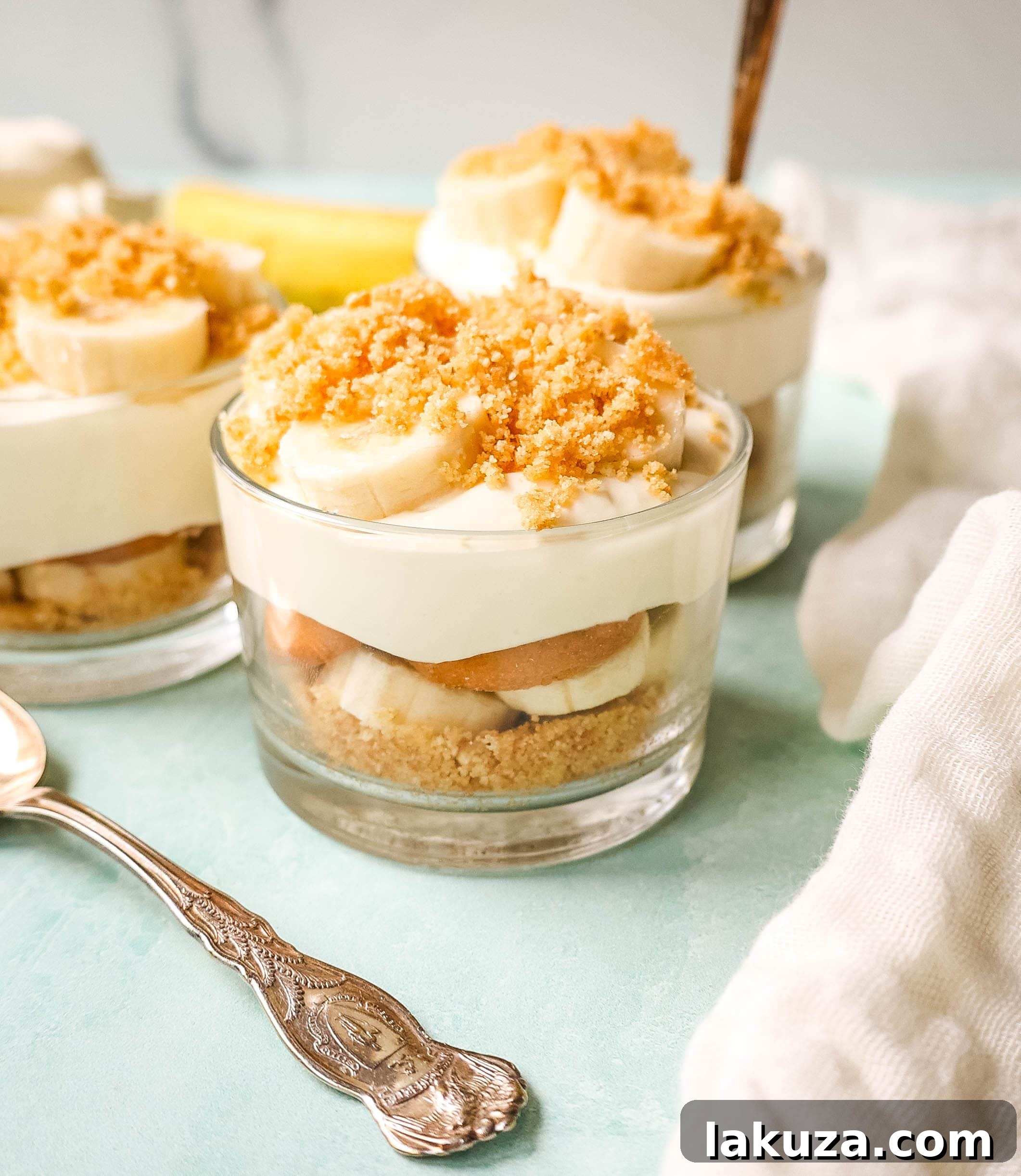 A close-up shot of homemade Magnolia Bakery banana pudding, showing layers of creamy vanilla pudding, ripe banana slices, and soft Nilla Wafers, ready to be chilled and enjoyed.