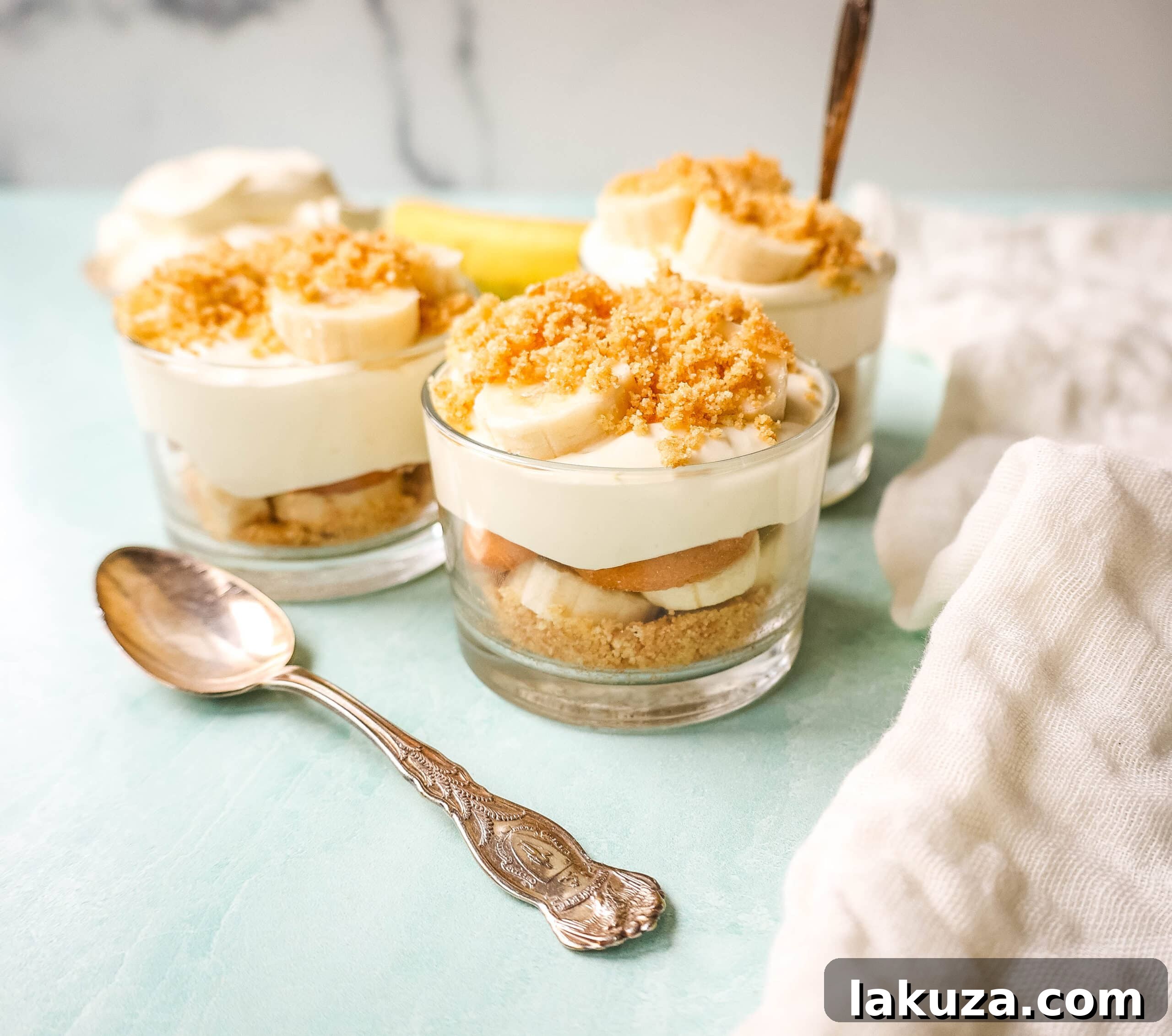 A beautifully layered homemade banana pudding, inspired by Magnolia Bakery's recipe, showcasing rich custard, fresh banana slices, and classic Nilla Wafers in a glass dish.
