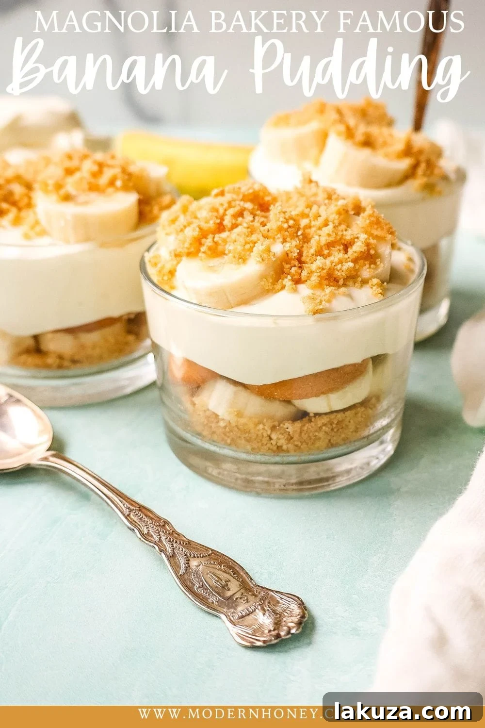 A single serving of Magnolia Bakery banana pudding in a glass jar, perfectly layered with creamy pudding, ripe bananas, and Nilla Wafers, garnished with a crumbled cookie.