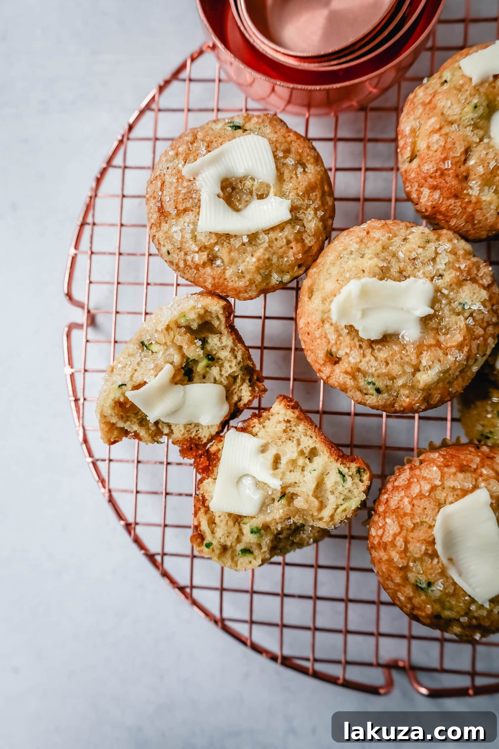Freshly baked zucchini muffins cooling on a wire rack, ready to be enjoyed as a perfect snack or breakfast item.