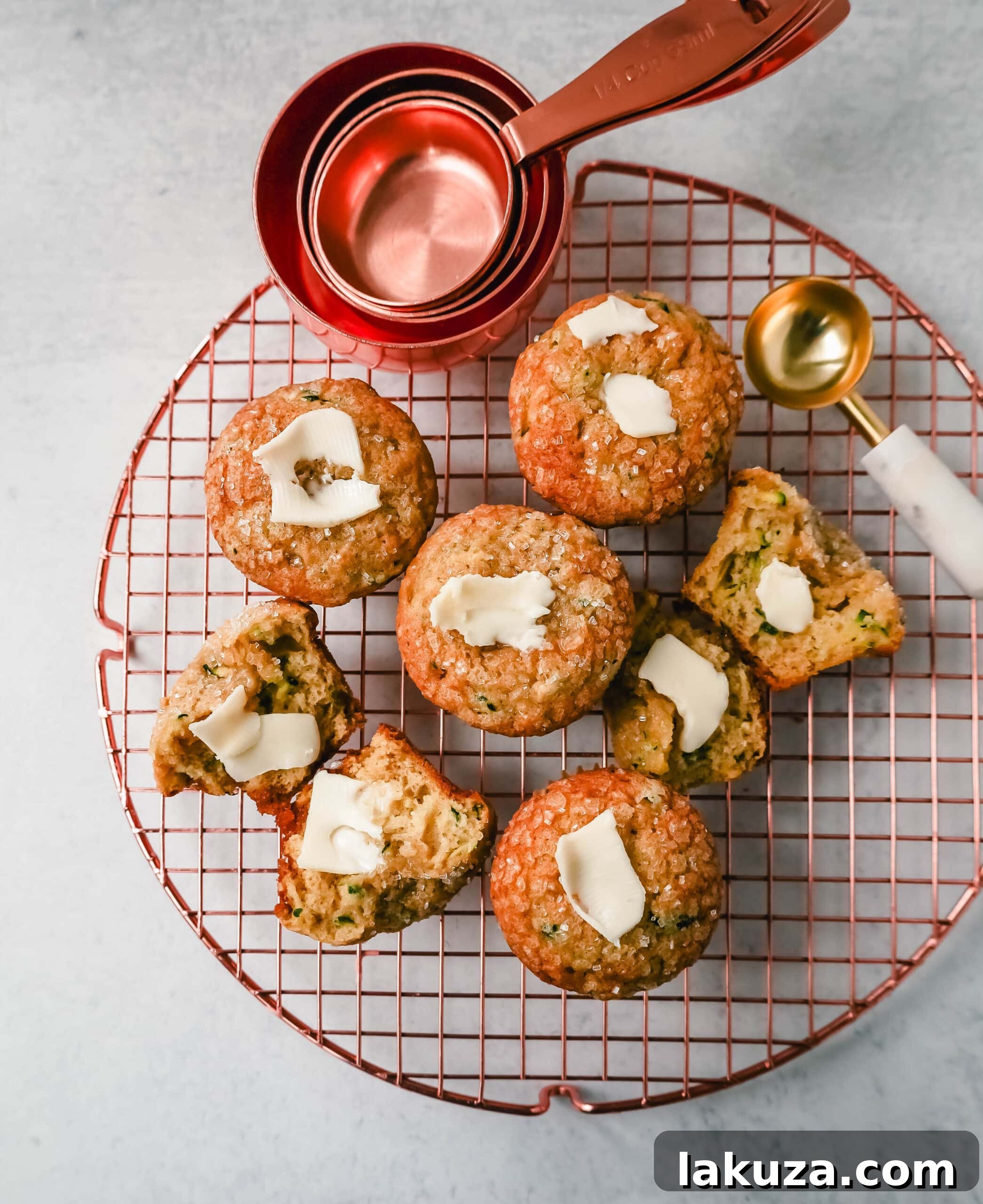 A top-down view of freshly baked zucchini muffins, showcasing their golden-brown tops and inviting texture.