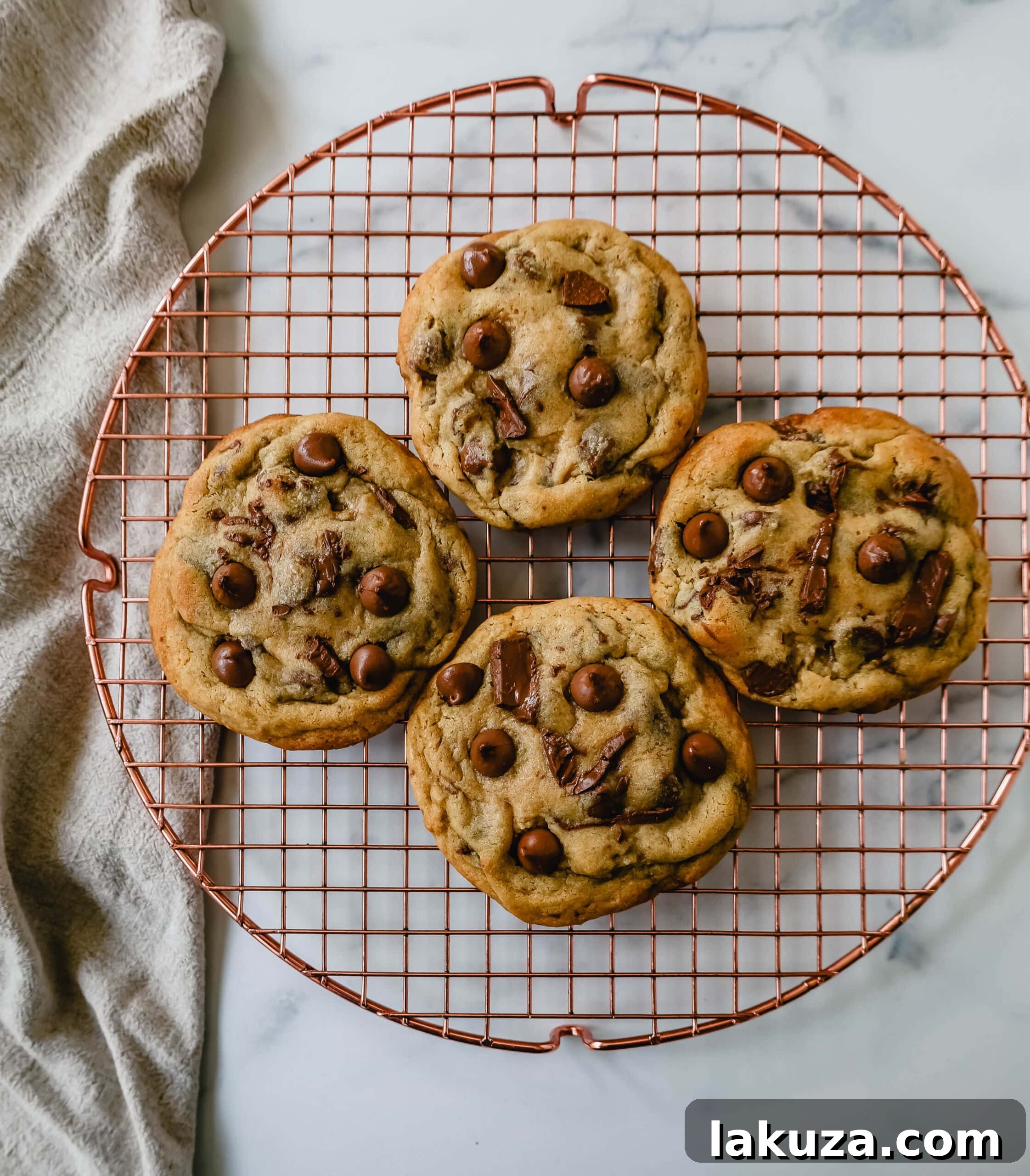 Irresistible Milk Chocolate Chip Delights 7 A large, golden milk chocolate chip cookie with a perfectly round shape, cooling on parchment paper. Expert baking tips.