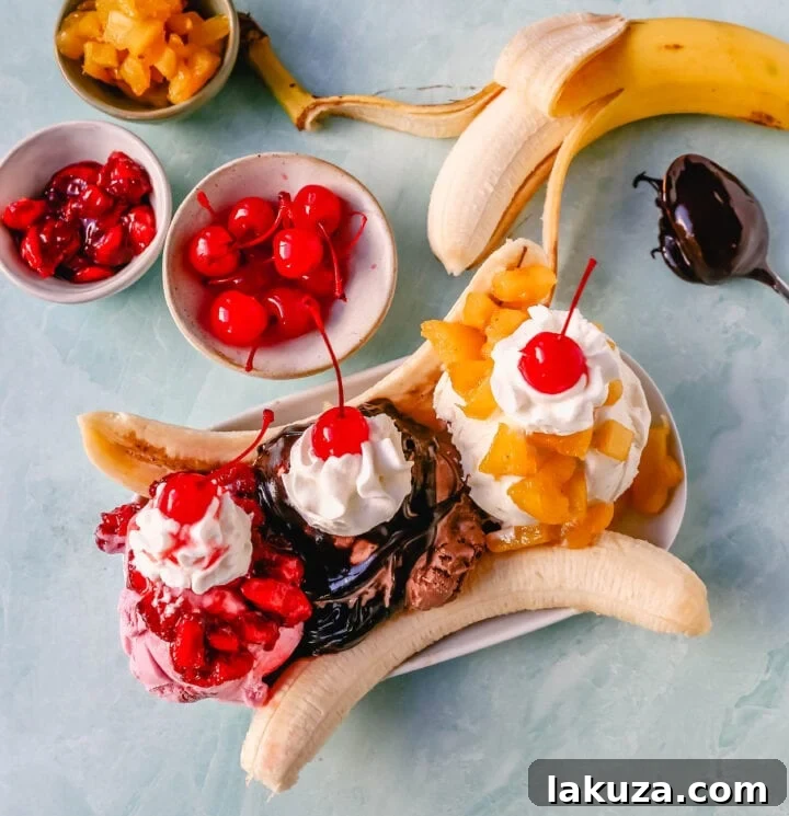 A classic Banana Split recipe made with fresh bananas, chocolate ice cream with hot fudge sauce, strawberry ice cream with strawberry sauce, vanilla ice cream with pineapple sauce, whipped cream, and cherry.