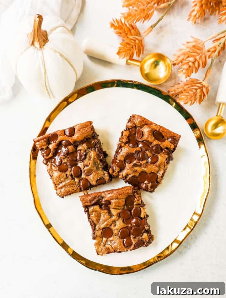 Pumpkin Chocolate Chip Bars are moist, chewy pumpkin spiced bars with chocolate chips. These pumpkin chocolate chip blondies are soft and chewy and perfect for Fall.