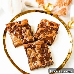Pumpkin Chocolate Chip Bars are moist, chewy pumpkin spiced bars with chocolate chips. These pumpkin chocolate chip blondies are soft and chewy and perfect for Fall.