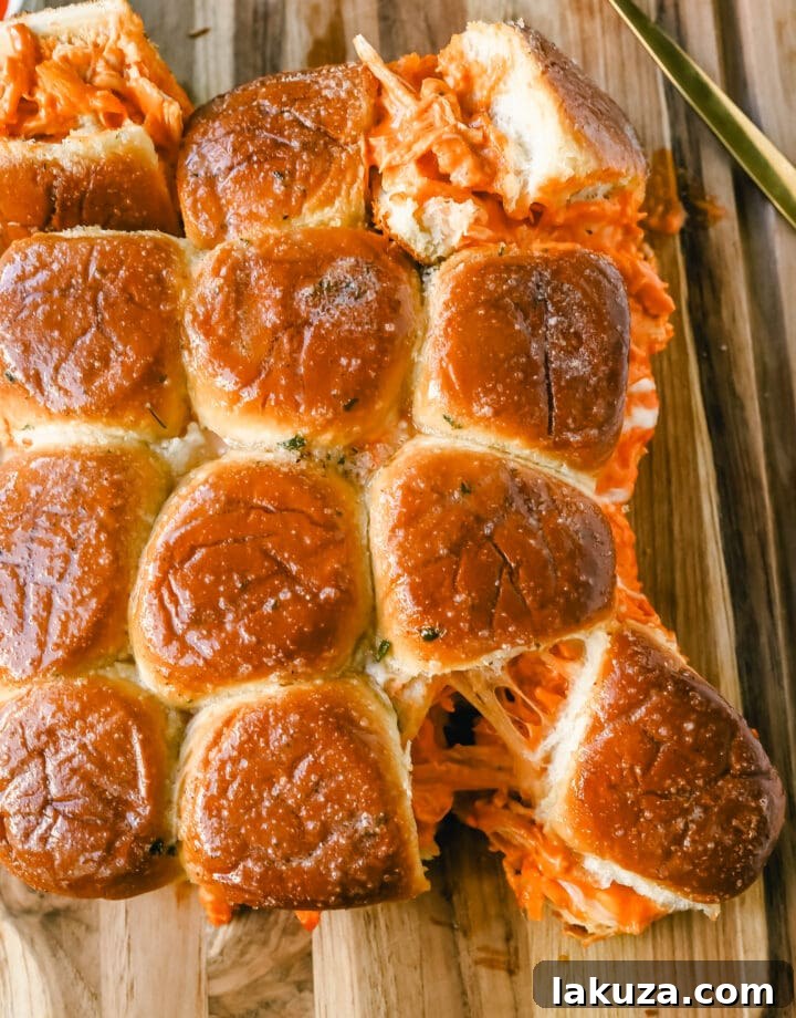 A tray of freshly baked Buffalo Chicken Sliders, ready to be served at a party.