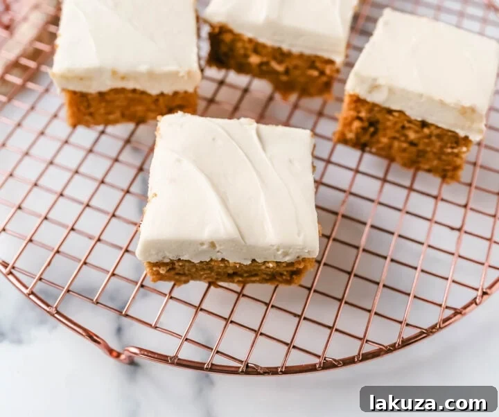 Spiced Pumpkin Bars with Tangy Cream Cheese Frosting 3 Close-up of fluffy Pumpkin Bars with Cream Cheese Frosting