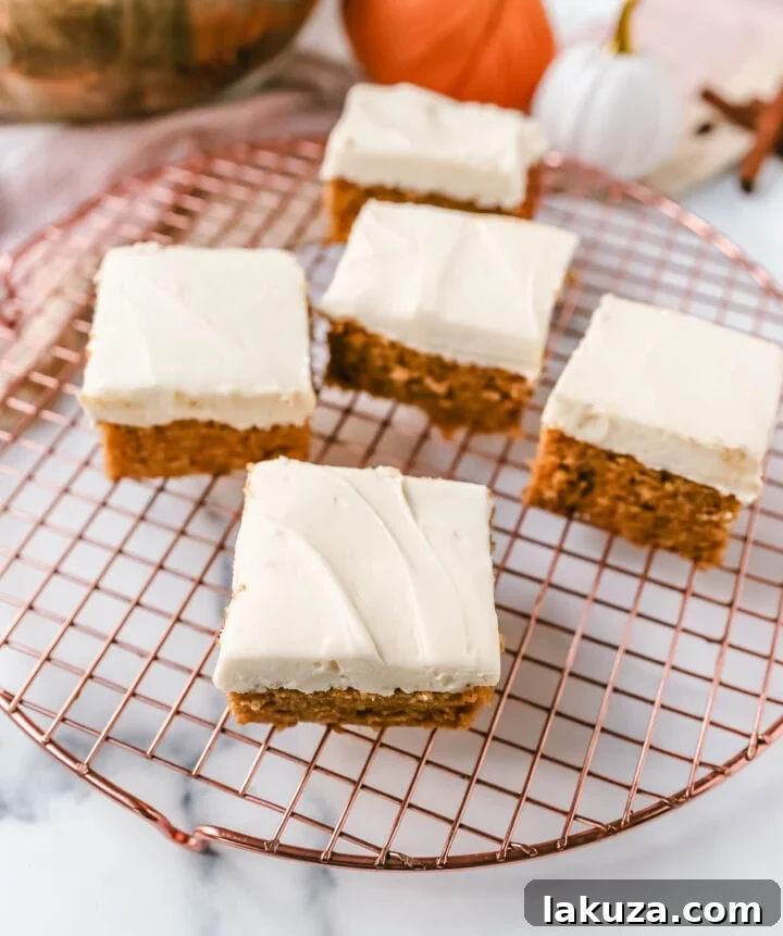 Spiced Pumpkin Bars with Tangy Cream Cheese Frosting 7 Sliced Pumpkin Bars with Cream Cheese Frosting ready to serve