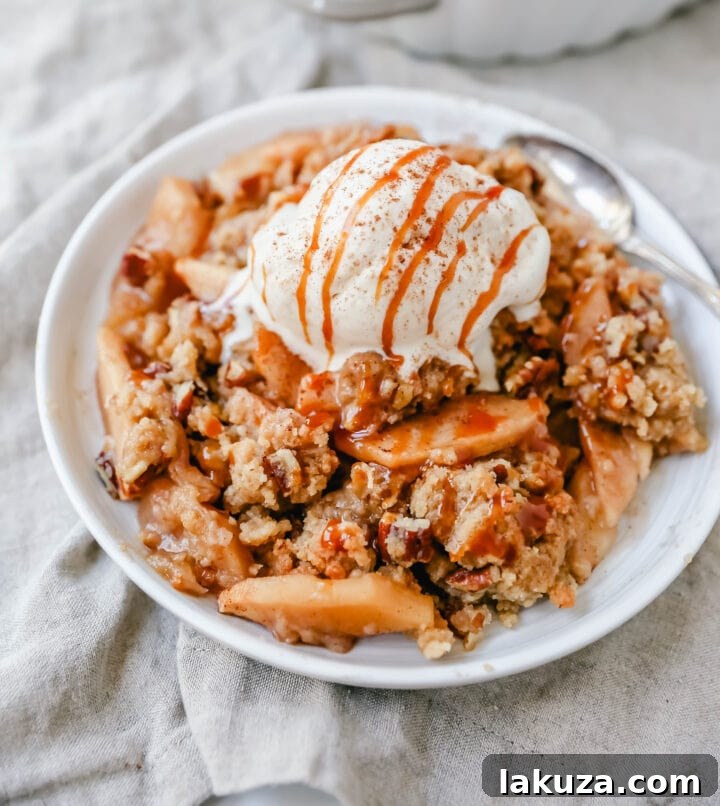 Simple Apple Crumble Bliss 3 Homemade Apple Crumble Recipe made with fresh apples tossed in cinnamon sugar and topped with a brown sugar crumble made with butter, pecans, brown sugar, and flour. This apple crumble is baked until bubbly and topped with vanilla ice cream. An easy apple dessert!
