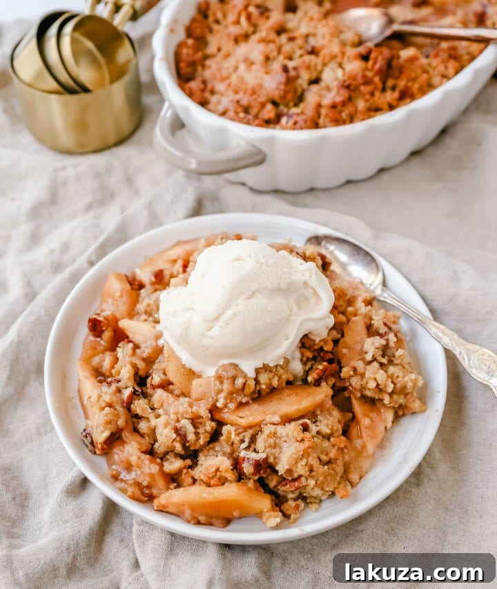 Simple Apple Crumble Bliss 4 Homemade Apple Crumble Recipe made with fresh apples tossed in cinnamon sugar and topped with a brown sugar crumble made with butter, pecans, brown sugar, and flour. This apple crumble is baked until bubbly and topped with vanilla ice cream. An easy apple dessert!