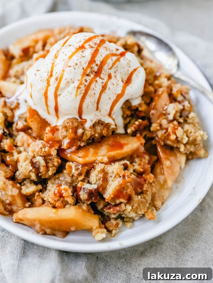 Simple Apple Crumble Bliss 5 Homemade Apple Crumble Recipe made with fresh apples tossed in cinnamon sugar and topped with a brown sugar crumble made with butter, pecans, brown sugar, and flour. This apple crumble is baked until bubbly and topped with vanilla ice cream. An easy apple dessert!