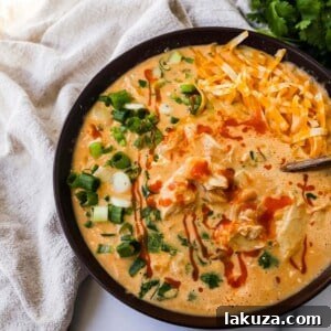Bold Buffalo Chicken Chili 5 A vibrant bowl of Creamy Buffalo Chicken Chili, garnished with fresh green onions and cilantro, ready to be served. A rich, comforting dish.
