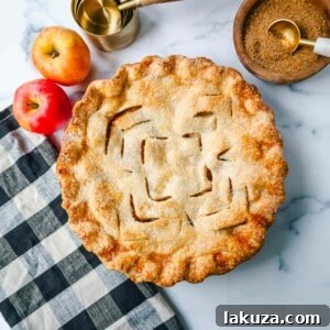 The Best Homemade Apple Pie Recipe! A golden brown, flaky crust apple pie sliced, revealing sweet apple filling.