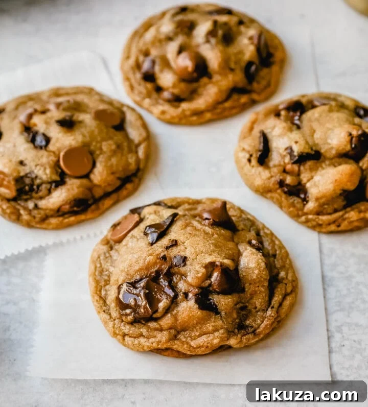 Irresistible Chocolate Chip Cookies 6 A batch of golden brown chocolate chip cookies cooling on a metal rack, ready to be devoured.