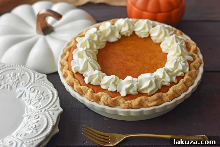 The BEST Pumpkin Pie Recipe: Creamy, sweet pumpkin pie with flaky crust and fresh whipped cream. First place bake-off winner!