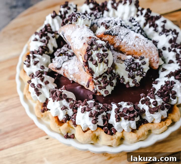 Cannoli Pie: Famous Italian dessert transformed into a pie with sweet ricotta, chocolate chips, ganache, and whipped cream.