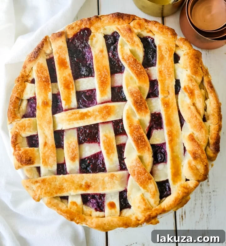 Triple Berry Pie: Best homemade berry pie with buttery crust, topped with vanilla bean ice cream, perfect berry dessert.