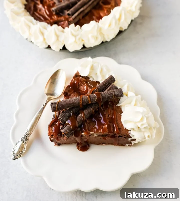 Rich Mexican Chocolate Cream Pie with a graham cracker and almond crust, topped with fresh whipped cream and a chocolate drizzle. Inspired by Elote Cafe.