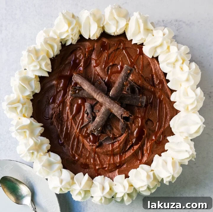 A slice of Mexican Chocolate Cream Pie on a plate, showcasing the thick chocolate filling, crumbly crust, and whipped cream topping with caramel drizzle.
