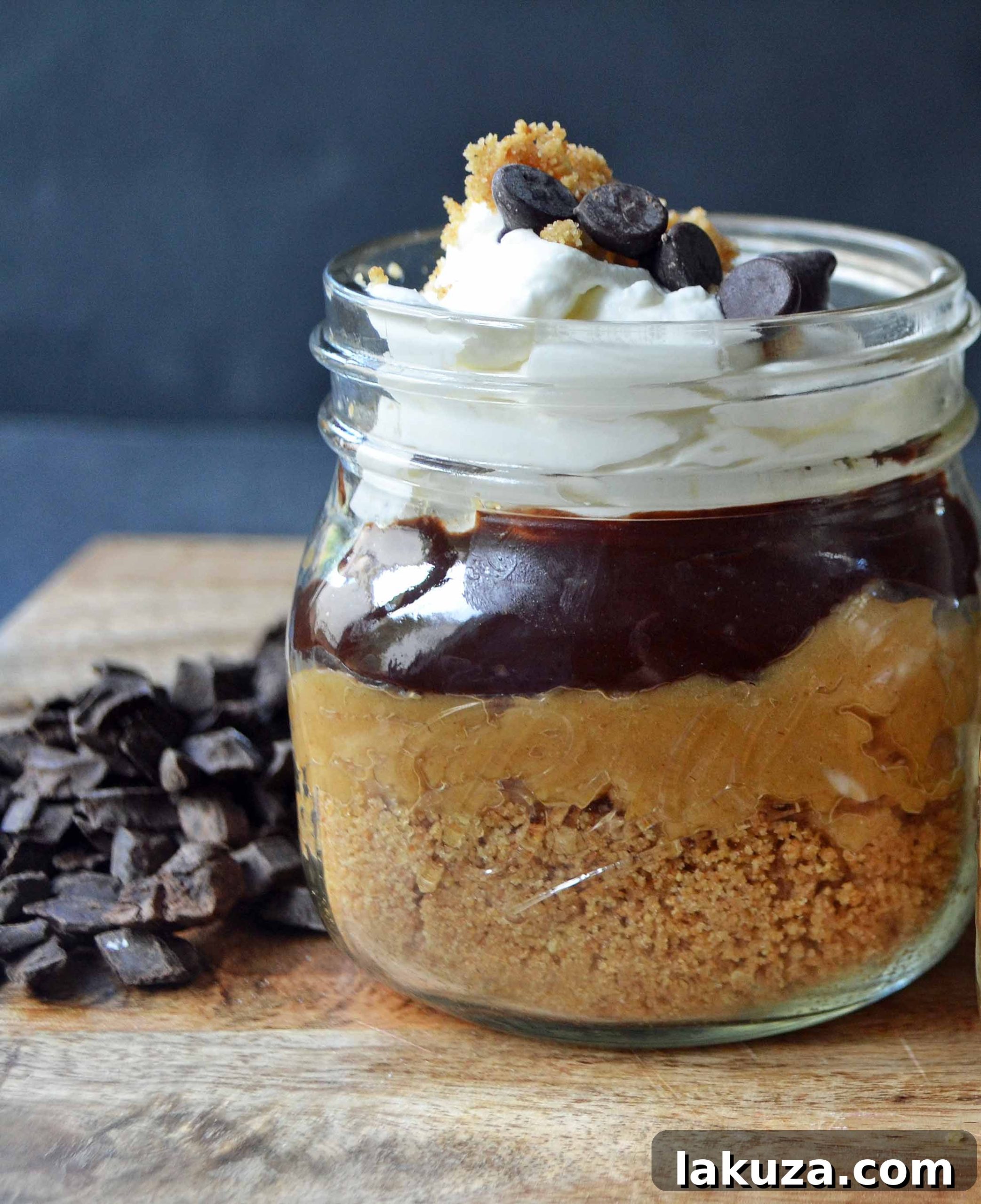 Close-up of Bachelor Peanut Butter Pie Jars with layers of graham cracker crust, creamy peanut butter, rich chocolate ganache, and fluffy whipped cream