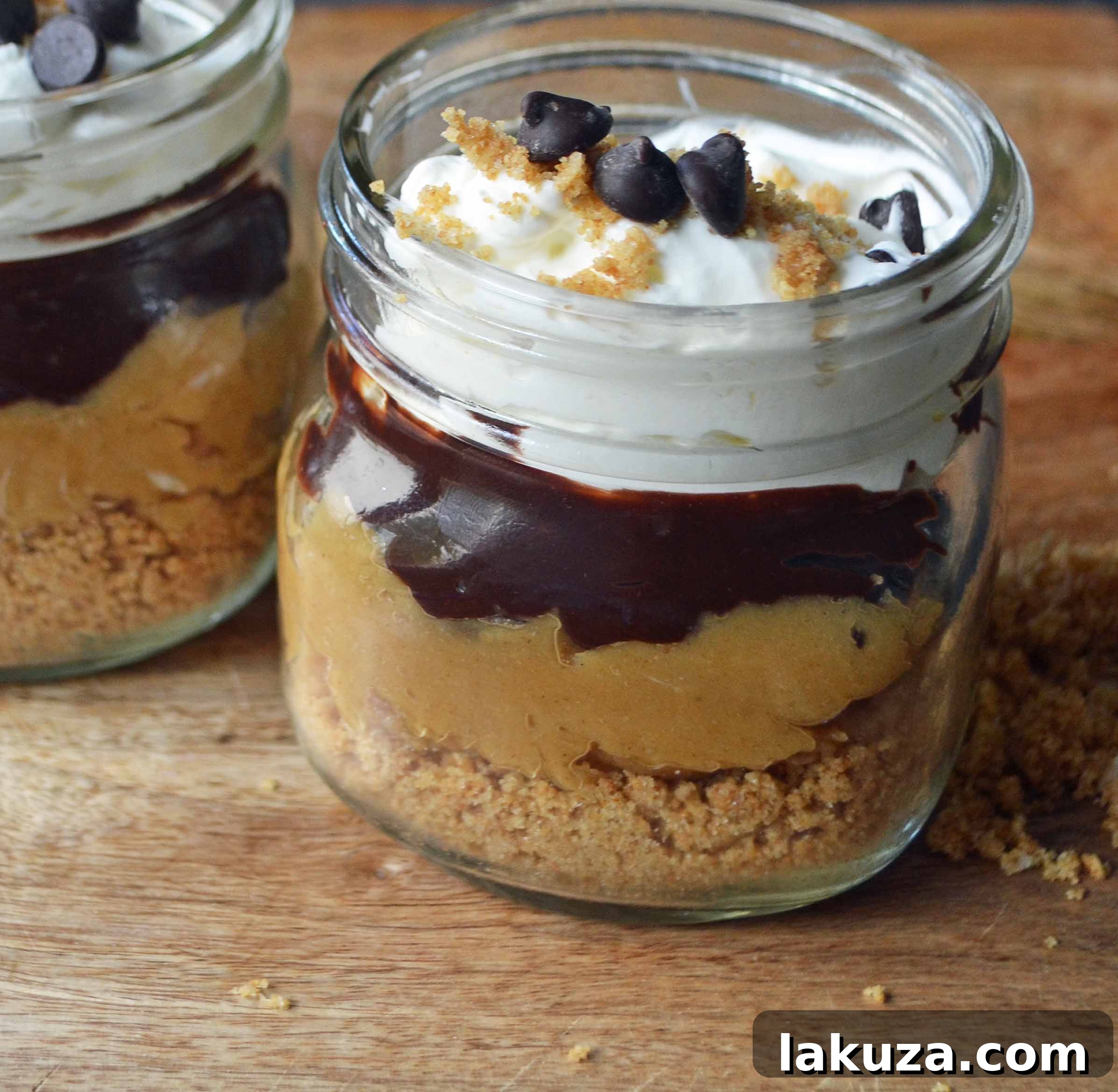 Individual serving of No-Bake Peanut Butter Pie in a Jar, topped with chocolate chips and whipped cream, perfect for sharing