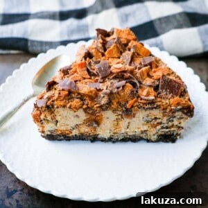 No-Bake Chocolate Peanut Butter Butterfinger Pie with a chocolate OREO crust, creamy peanut butter filling with Butterfinger candy bars, chocolate ganache, and topped with fresh whipped cream and Butterfinger. The best creamy Butterfinger pie recipe!