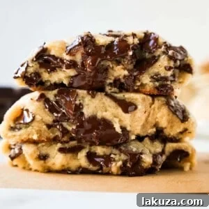 Levain Bakery Two Chip Chocolate Chip Cookie Recipe is their classic chocolate chip cookie made without nuts. Perfectly crispy on the outside and satisfyingly thick and gooey in the center, this cookie is brimming with semi-sweet and dark chocolate chips.