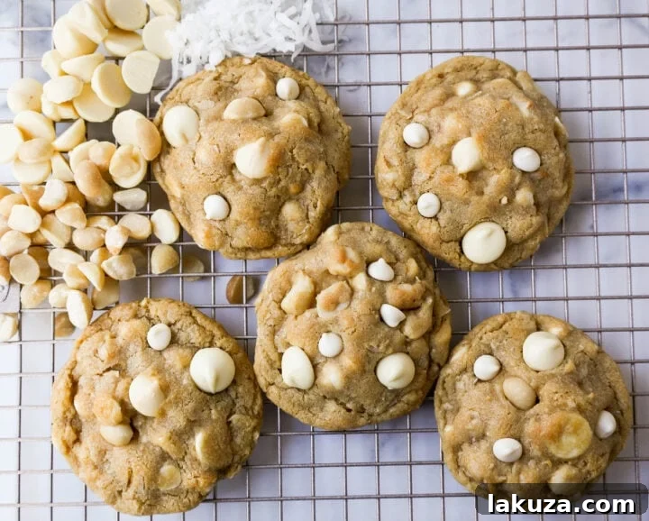 Beautifully arranged White Chocolate Coconut Macadamia Nut Cookies on a baking sheet.