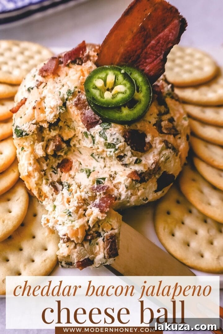 A stunning spread featuring the Cheddar Bacon Jalapeño Cheese Ball as the star, surrounded by an assortment of crackers and garnishes, ready for a festive gathering.