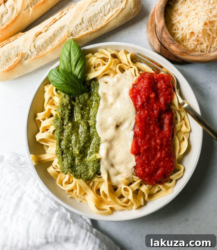 Festive Triple-Sauce Pasta with creamy Alfredo, rich Marinara, and vibrant Pesto for a perfect holiday meal.