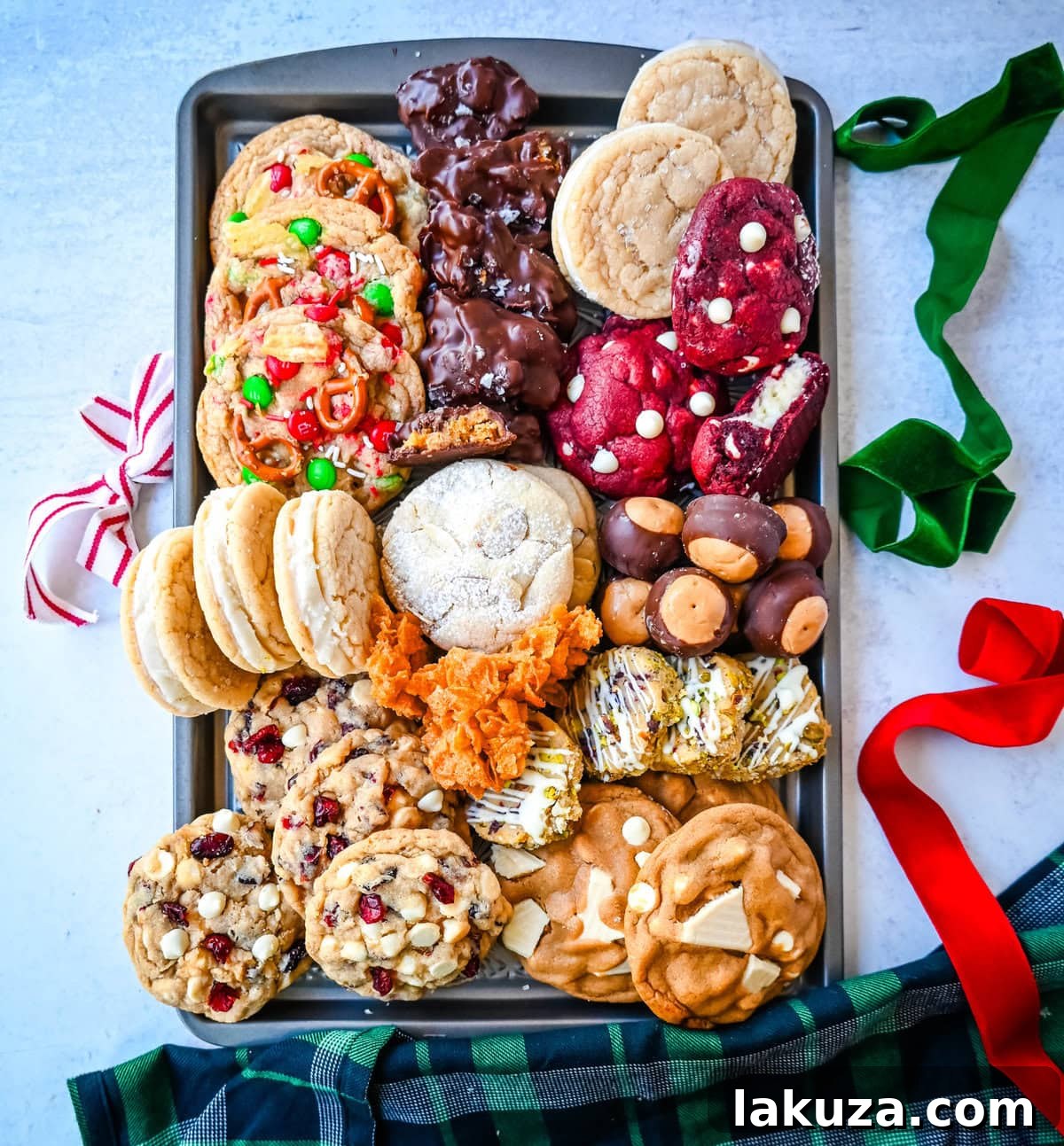 80 Irresistible Christmas Cookie Recipes 102 Christmas Cookie Box. An assortment of homemade Christmas cookies cooling on a baking tray, ready for the box.