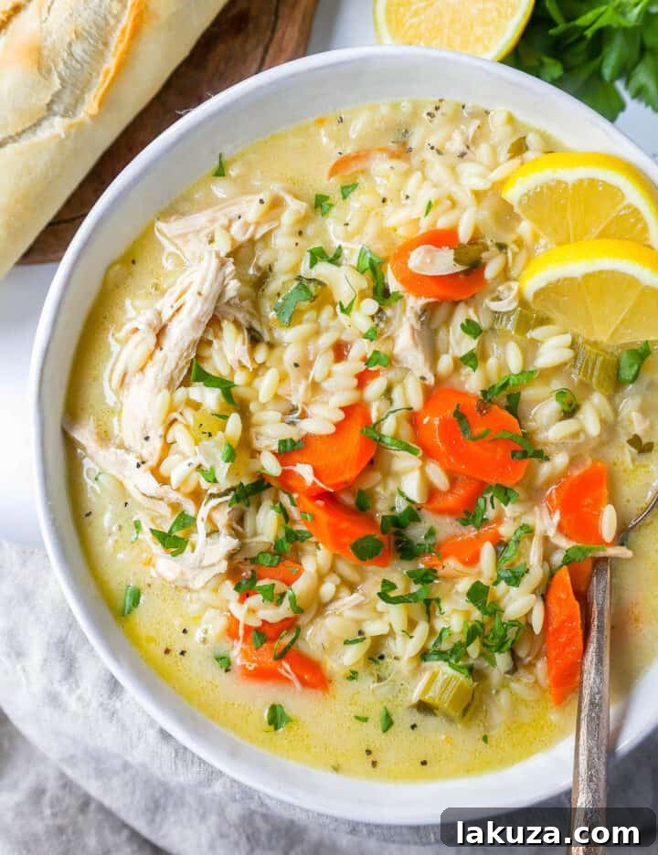 Fresh ingredients for Lemon Chicken Orzo Soup laid out on a cutting board, including vibrant lemons, crisp vegetables, and succulent chicken.