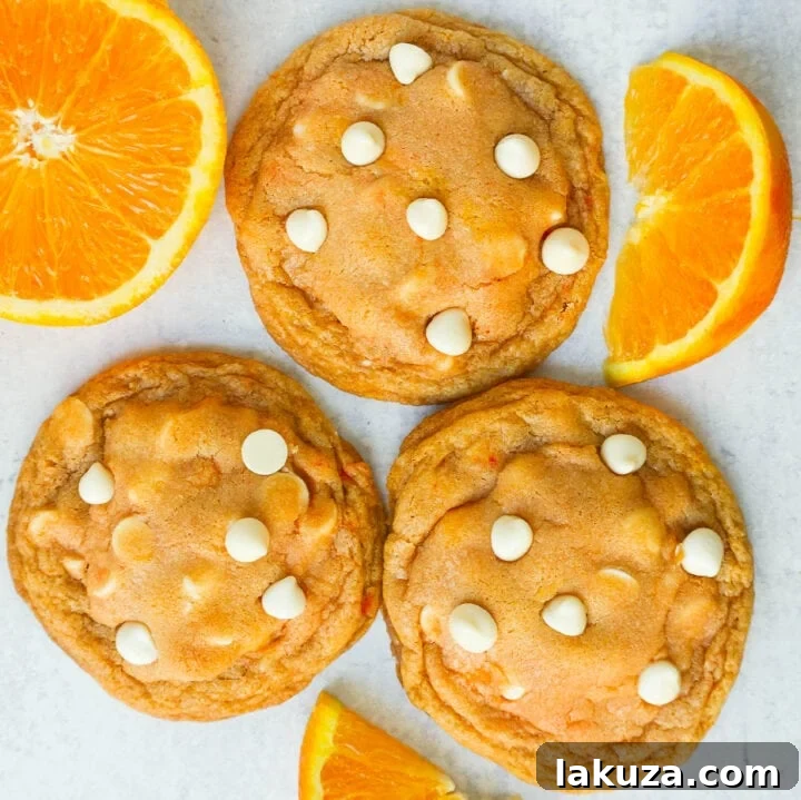 Soft and Chewy Orange Creamsicle Cookies made with fresh orange zest and juice and white chocolate chips. This Orange White Chocolate Cookie recipe is the perfect orange cookie.