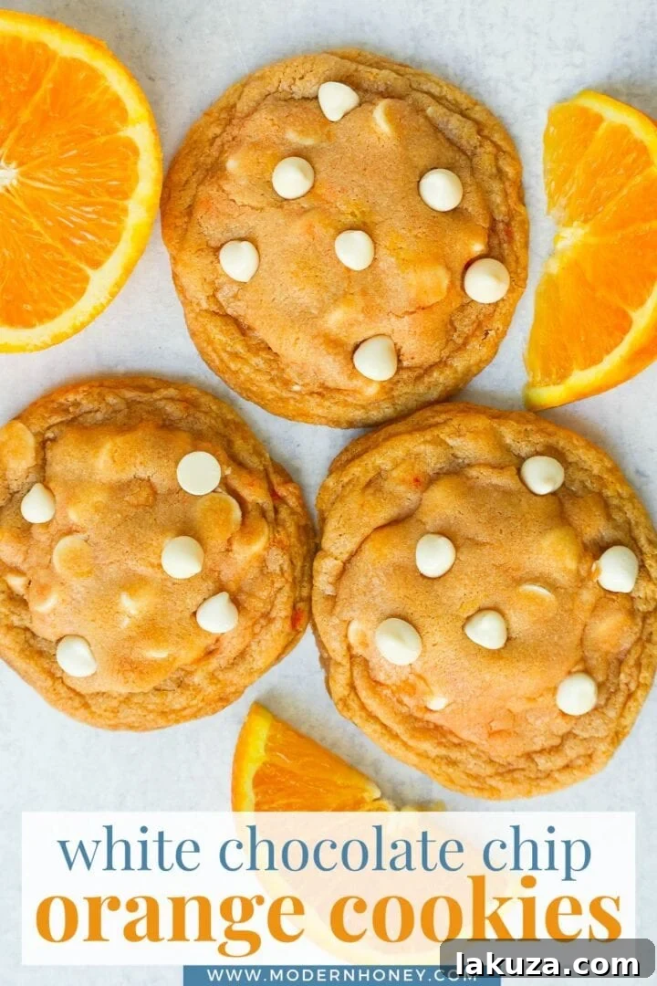 A stunning close-up shot of several Soft and Chewy Orange Creamsicle Cookies, emphasizing their beautiful texture and golden hue.