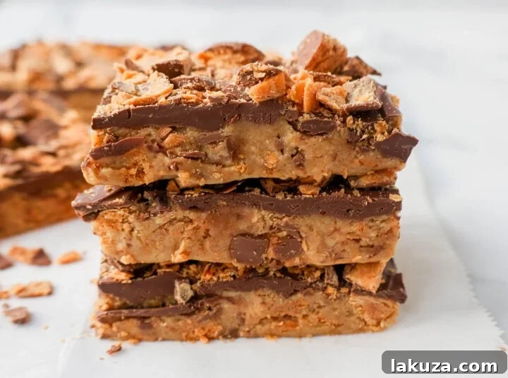 Ultimate Butterfinger Crunch Bars 5 A tray of perfectly cut No-Bake Butterfinger Bars, ready to be enjoyed as a sweet and crunchy dessert.