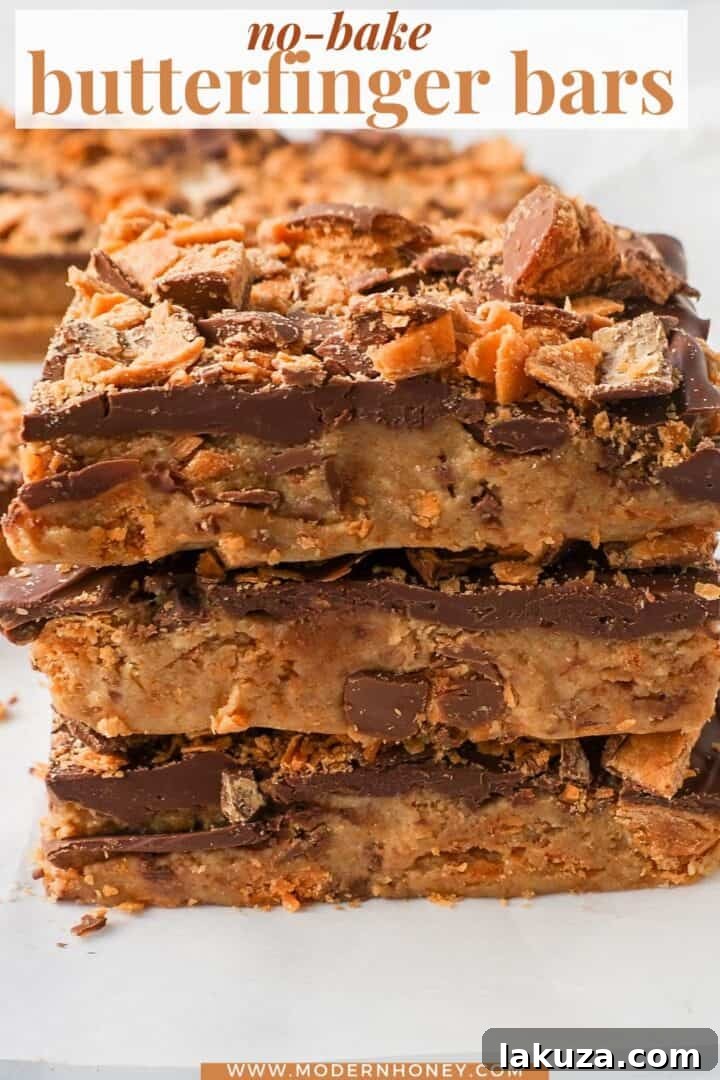 Ultimate Butterfinger Crunch Bars 8 A large batch of No-Bake Crunchy Butterfinger Bars, showcasing the rich chocolate layer and generous Butterfinger topping on a white background.