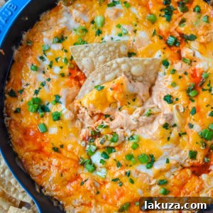 This Hot Creamy Buffalo Chip Dip is made with tender shredded chicken, cream cheese, buffalo sauce, ranch dressing, and topped with cheese, and baked until warm and bubbly. This is a perfect Super Bowl appetizer and this Chicken Hot Wing Dip is always a hit!