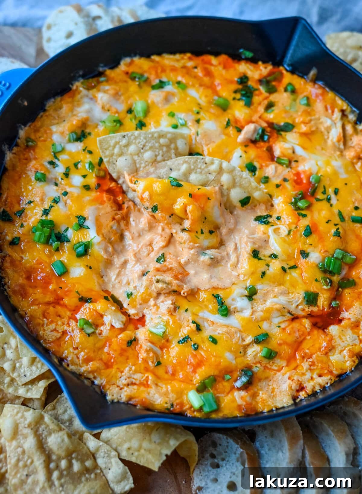 This Hot Creamy Buffalo Chip Dip is made with tender shredded chicken, cream cheese, buffalo sauce, ranch dressing, and topped with cheese, and baked until warm and bubbly. This is a perfect Super Bowl appetizer and this Chicken Hot Wing Dip is always a hit!