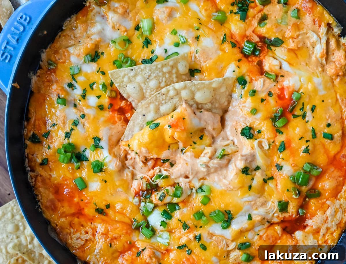 This Hot Creamy Buffalo Chip Dip is made with tender shredded chicken, cream cheese, buffalo sauce, ranch dressing, and topped with cheese, and baked until warm and bubbly. This is a perfect Super Bowl appetizer and this Chicken Hot Wing Dip is always a hit!