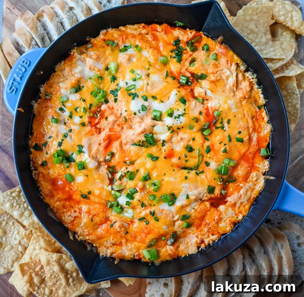 This Hot Creamy Buffalo Chip Dip is made with tender shredded chicken, cream cheese, buffalo sauce, ranch dressing, and topped with cheese, and baked until warm and bubbly. This is a perfect Super Bowl appetizer and this Chicken Hot Wing Dip is always a hit!