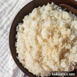 This easy 5-ingredient Coconut Rice recipe, made with jasmine rice, coconut milk, water, sugar, and salt, is a perfect savory side dish with a hint of sweet tropical flavor.