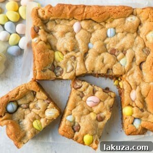 These Easter Cadbury Mini Eggs Blondies are chewy milk chocolate chip cookie bars filled with mini Cadbury eggs. These are the best mini egg blondies!