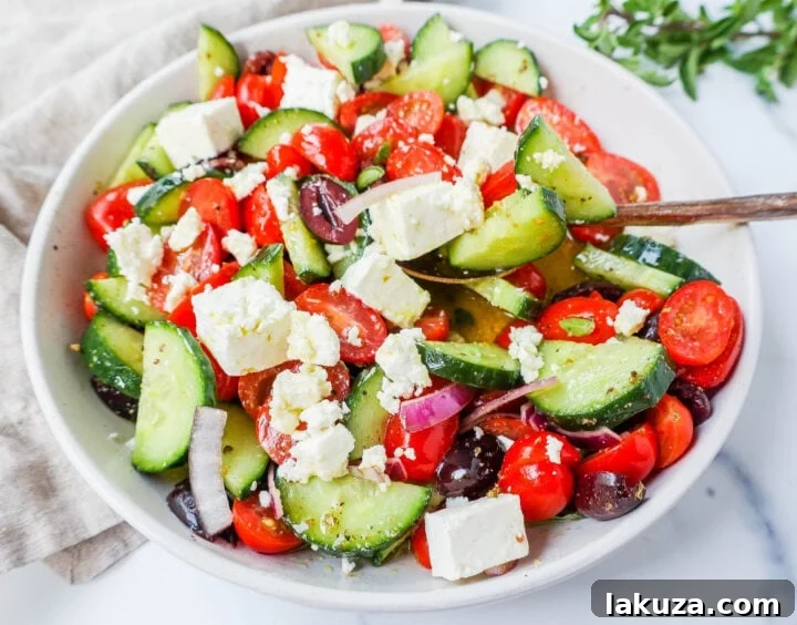 Generous serving of Greek Salad with a focus on its fresh ingredients and light dressing.