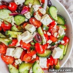 This simple Greek Salad is made with fresh tomatoes, cucumbers, red onion, kalamata olives, feta cheese, and all tossed with a homemade tangy Greek dressing.