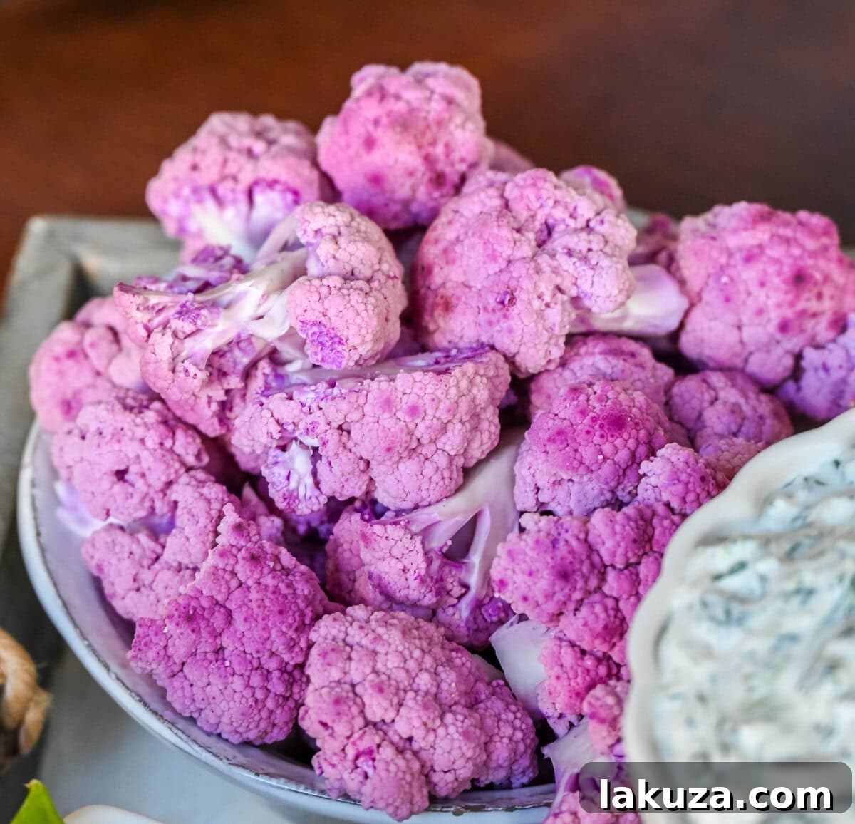 Purple cauliflower on crudite platter or vegetable board.