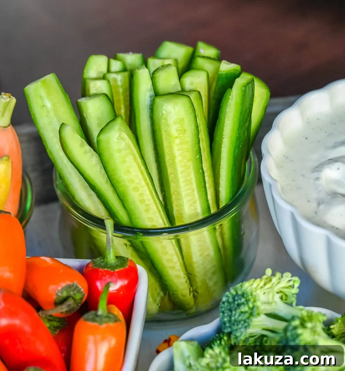 Hot House or English cucumbers in a jar on a crudite platter or veggie tray.